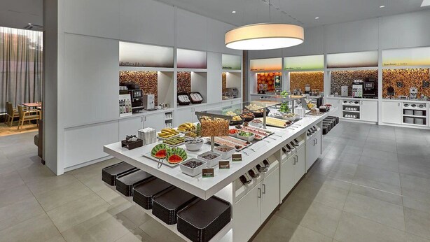 A modern breakfast bar with a variety of food options and a coffee station. - Complimentary Breakfast & City Views! Pergamon Museum - 0.9 mile away! (Berlin)