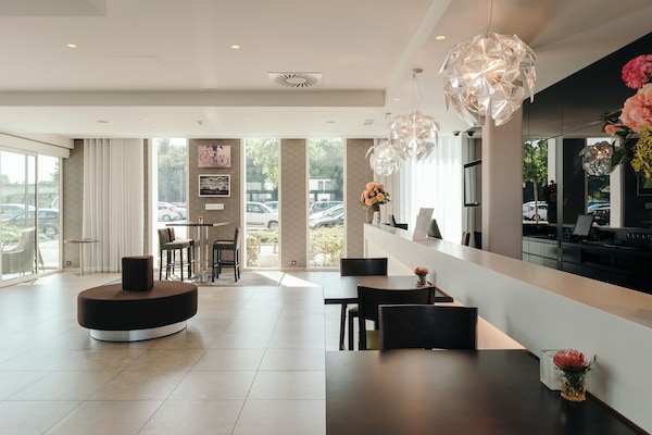 Check in effortlessly in a bright lobby with designer lighting.