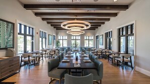 A spacious conference room with long tables, comfortable chairs, and large windows allowing natural light. - 8905 Solara 9bd 22sleep/pool (Davenport)
