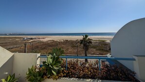 A balcony with a view of a beach and ocean. - 182 Livingtarifa Famara (Tarifa)