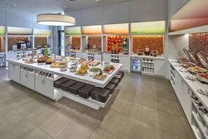 A buffet with various food items and a self-service beverage station.