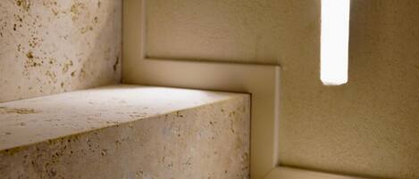 A clean, modern staircase with minimalistic design and recessed lighting.