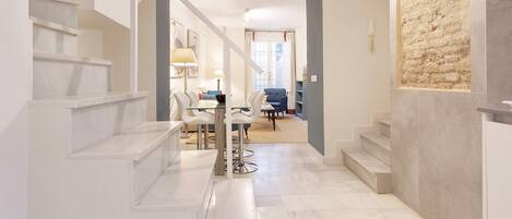 A modern interior with a staircase leading to a dining area.
