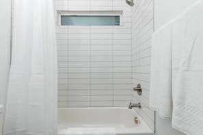 Shower, hair dryer, towels, shampoo