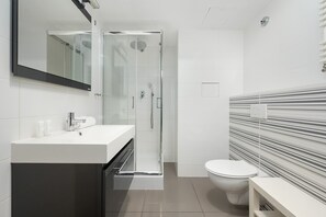 Shower, hair dryer, towels, shampoo