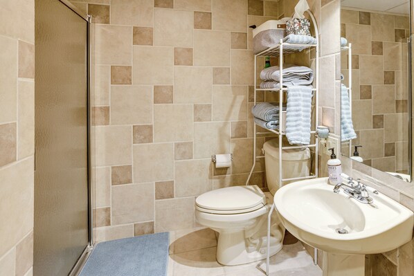 A bathroom with a toilet, sink, and towel rack. - Swim, Fish & Boat: House on Stunning Higgins Lake! (Roscommon)