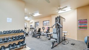 A gym with various exercise equipment, a rack of dumbbells, and a poster on the wall. - 1 Mi to Golf: Lake-view Condo w/ Pool in Chandler! (Chandler)