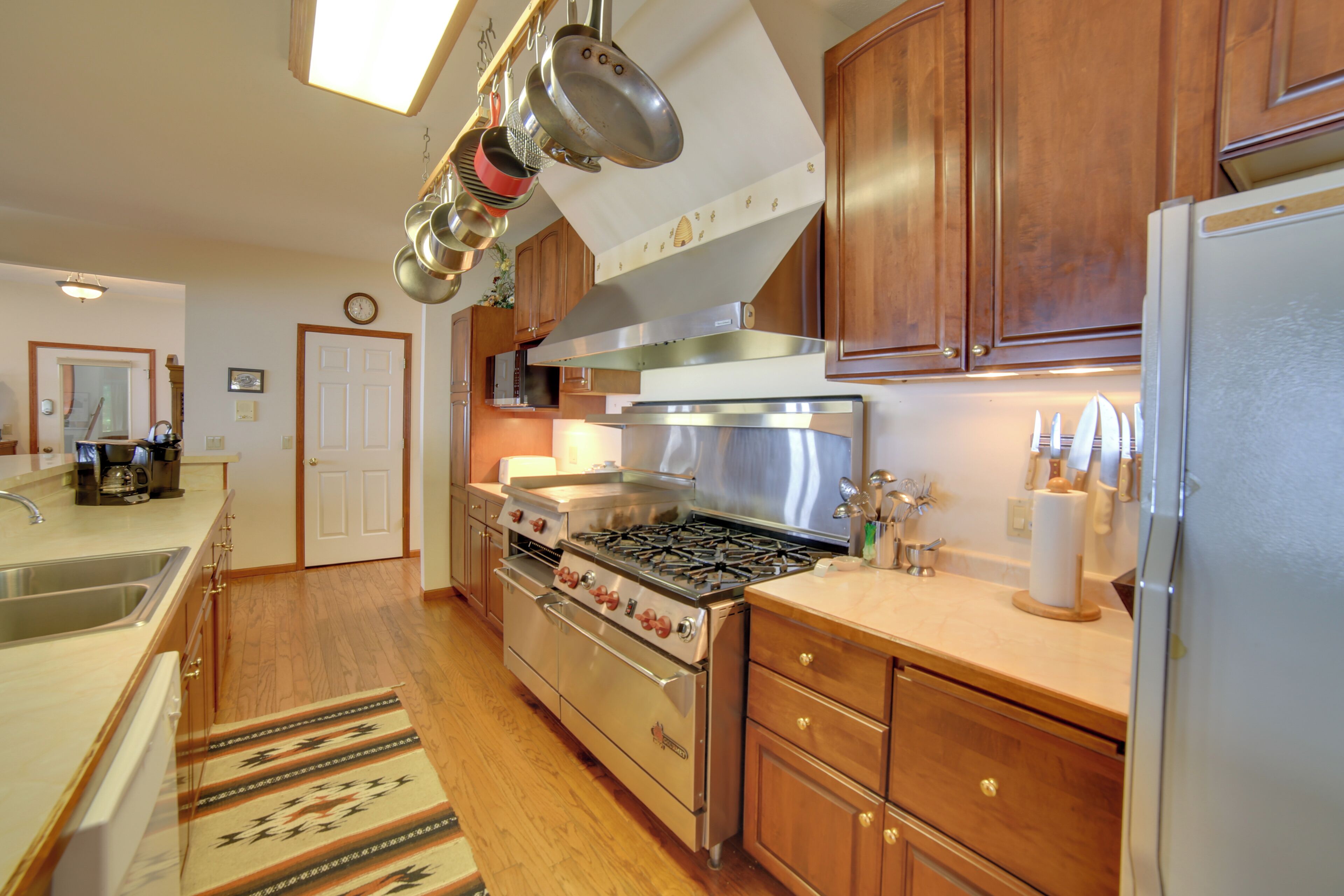 A kitchen with wooden cabinets, stainless steel appliances, and a built-in oven.