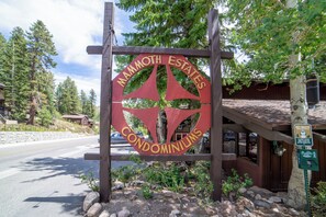 A wooden sign with the text 'Mammoth Estates Condominiums' indicating a residential area.
