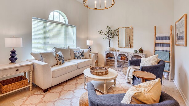 A well-lit living room with a sofa, armchairs, a coffee table, and a chandelier. - 30A Poolside Oasis: 2 Mi to Beach & Boat Access (Santa Rosa Beach)