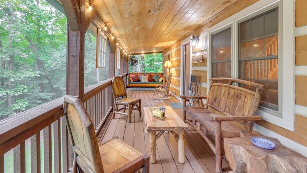 A wooden deck with a sofa, chairs, and a table. - Escape to the Mountains: Hot Tub Haven in Ellijay! (Ellijay)