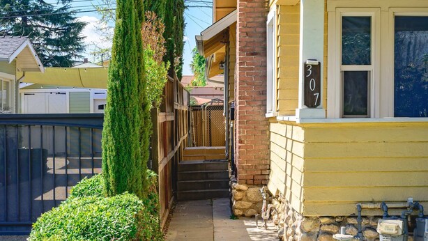A residential house with a stone foundation, a brick roof, and a number '307' on the window. - Near LA Cozy Home With Full Kitchen Laundry (San Gabriel)