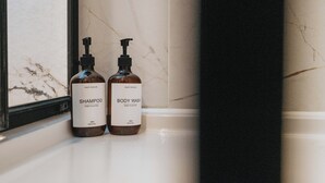Two bottles of shampoo and body wash on a bathroom counter. - Bold St | Football & Nightlife | Centre City Stay (Liverpool)