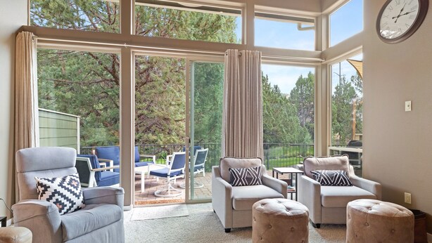 A spacious living room with a large sliding glass door leading to an outdoor patio area. - Brighter Days 3 Bedroom Townhouse (Redmond)