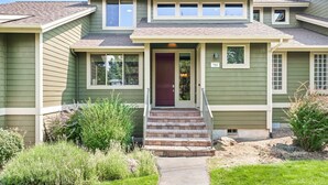 A two-story house with a front porch, a red door, and a number 782 on the house. - Brighter Days 3 Bedroom Townhouse (Redmond)
