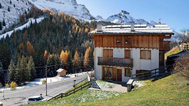 A wooden chalet with a balcony, a mountain backdrop, and a clear sky. - Apartment 'Sunny Arabba' with Mountain View, Private Garden and Wi-Fi (Arabba)