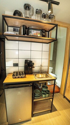 Mini-fridge, oven, stovetop, cookware/dishes/utensils