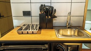 Mini-fridge, oven, stovetop, cookware/dishes/utensils