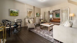 A living room with a dining area, a sofa, a coffee table, and a TV.