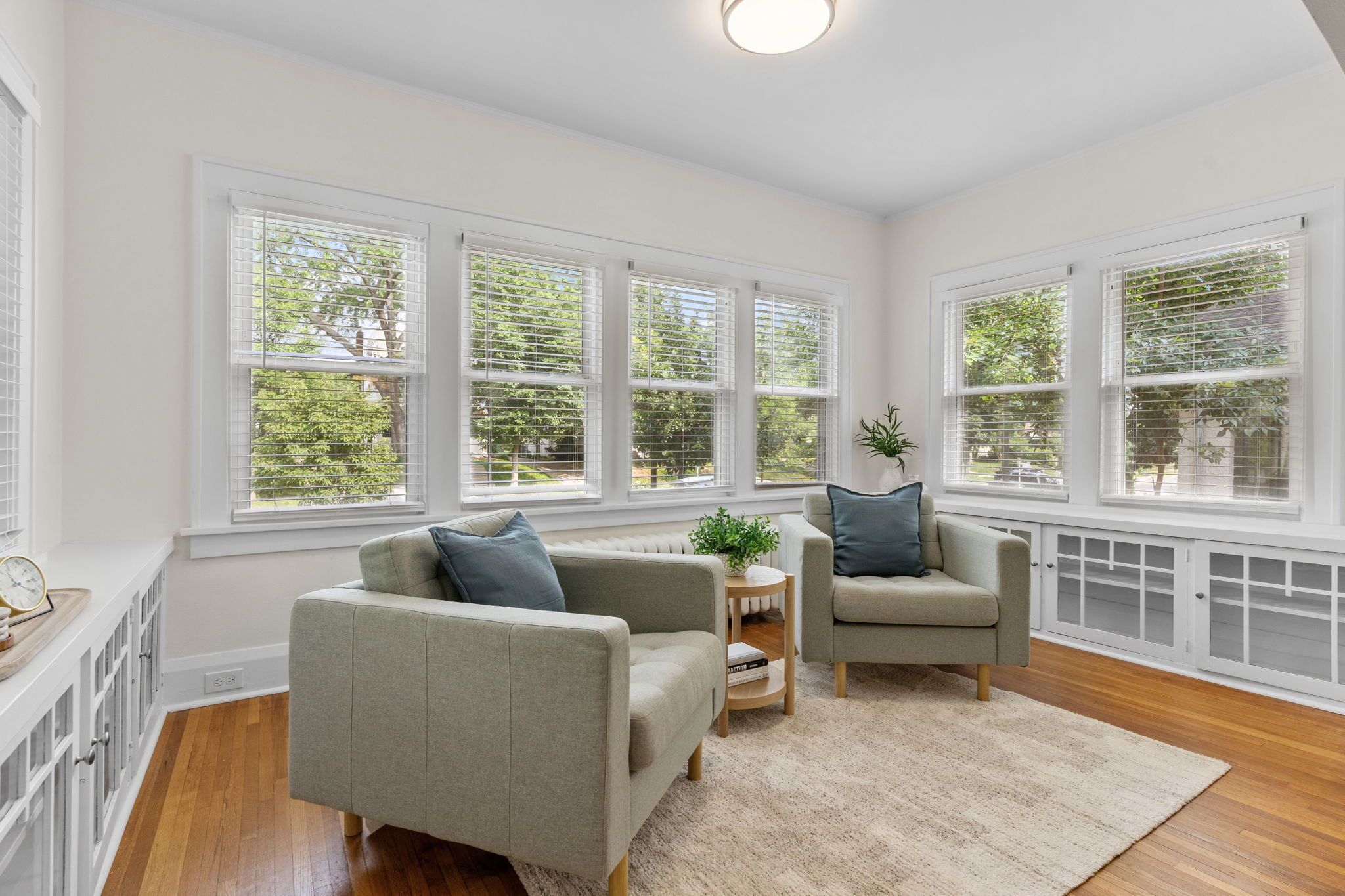 A spacious living room with large windows, a fireplace, and a cozy seating area.