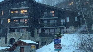A multi-story building with a stone facade and multiple balconies, surrounded by snow. - Bright, spacious apartment 100m from village center and ski lift (La Plagne Tarentaise)