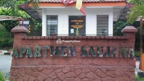 A sign for 'APARTMEN SAUJANA' with a stone base and a tiled roof. - Cosy Home in Damansara (Sungai Buloh)