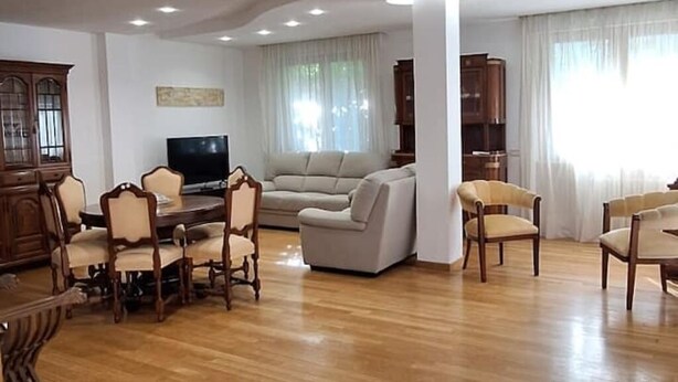 A spacious living room with a wooden dining table, beige sofas, and a flat-screen TV. - Semi-detached house-Francavilla al mare (Francavilla al Mare)
