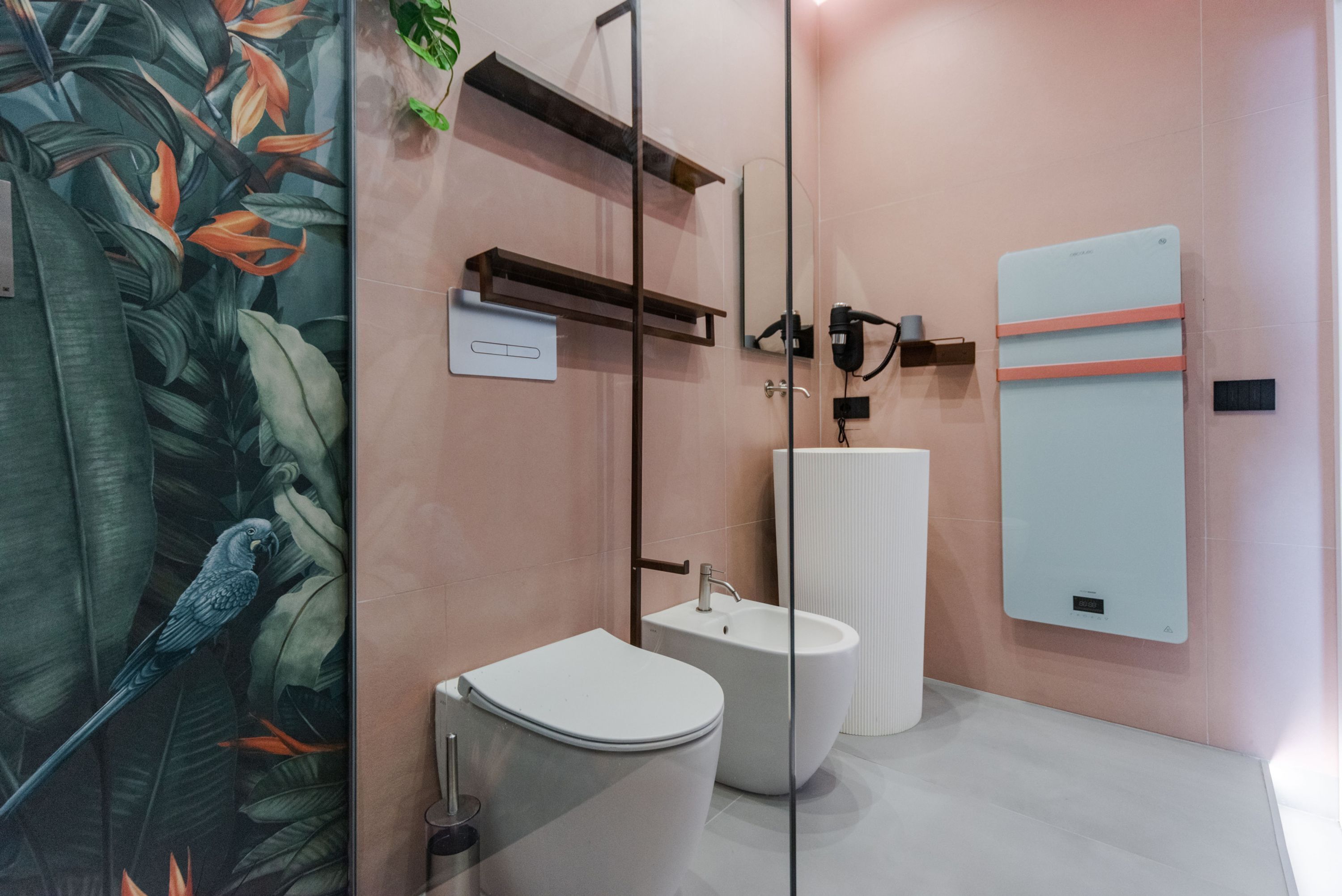 A modern bathroom with a toilet, bidet, and a large mirror.