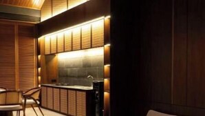 A modern interior with a kitchen area, a seating area with a sofa and ottoman, and a dining table with chairs. - 2bedrooms garden view villa unit 2 (Badung Regency, Bali)