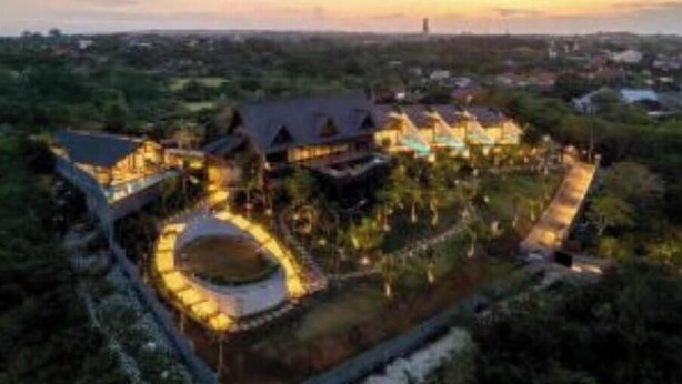 An aerial view of a resort with multiple buildings, a central circular courtyard, and surrounding greenery. - 2bedrooms garden view villa unit 2 (Badung Regency, Bali)