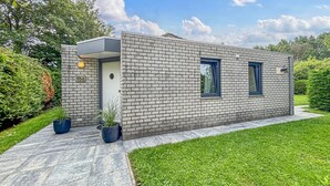 A modern brick building with a flat roof, a small entrance, and two windows. - Nice home in Dirkshorn with WiFi (Dirkshorn)