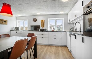Fridge, stovetop, dishwasher, coffee/tea maker