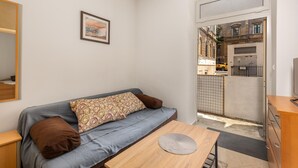 A small, modern living space with a sofa, a coffee table, and a framed picture on the wall. - 1 bedroom stunning apartment in Rijeka (Rijeka)