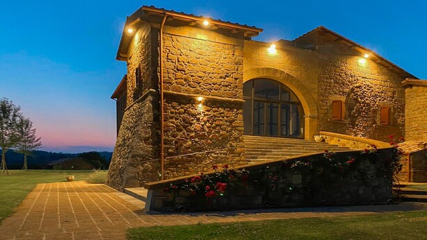 A stone building with a staircase leading to a door, surrounded by a well-maintained lawn and a clear sky. - Pet friendly apartment in Lubriano with sauna (Lubriano)