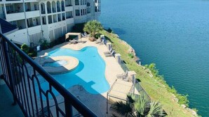 A large building with a swimming pool and a view of the water. - Hill Country Island Retreat - Loaded With Amenities! (Leander)