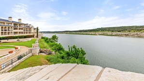 A hotel with a view of a river, stone steps, and a landscaped garden. - Hill Country Island Retreat - Loaded With Amenities! (Leander)