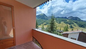 Ein Balkon mit Blick auf eine gebirgige Landschaft.