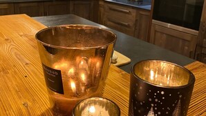 A kitchen with wooden cabinets, a stainless steel oven, and a coffee maker on the counter. - Chalet for 8 facing south, terrace, private parking (Valloire)