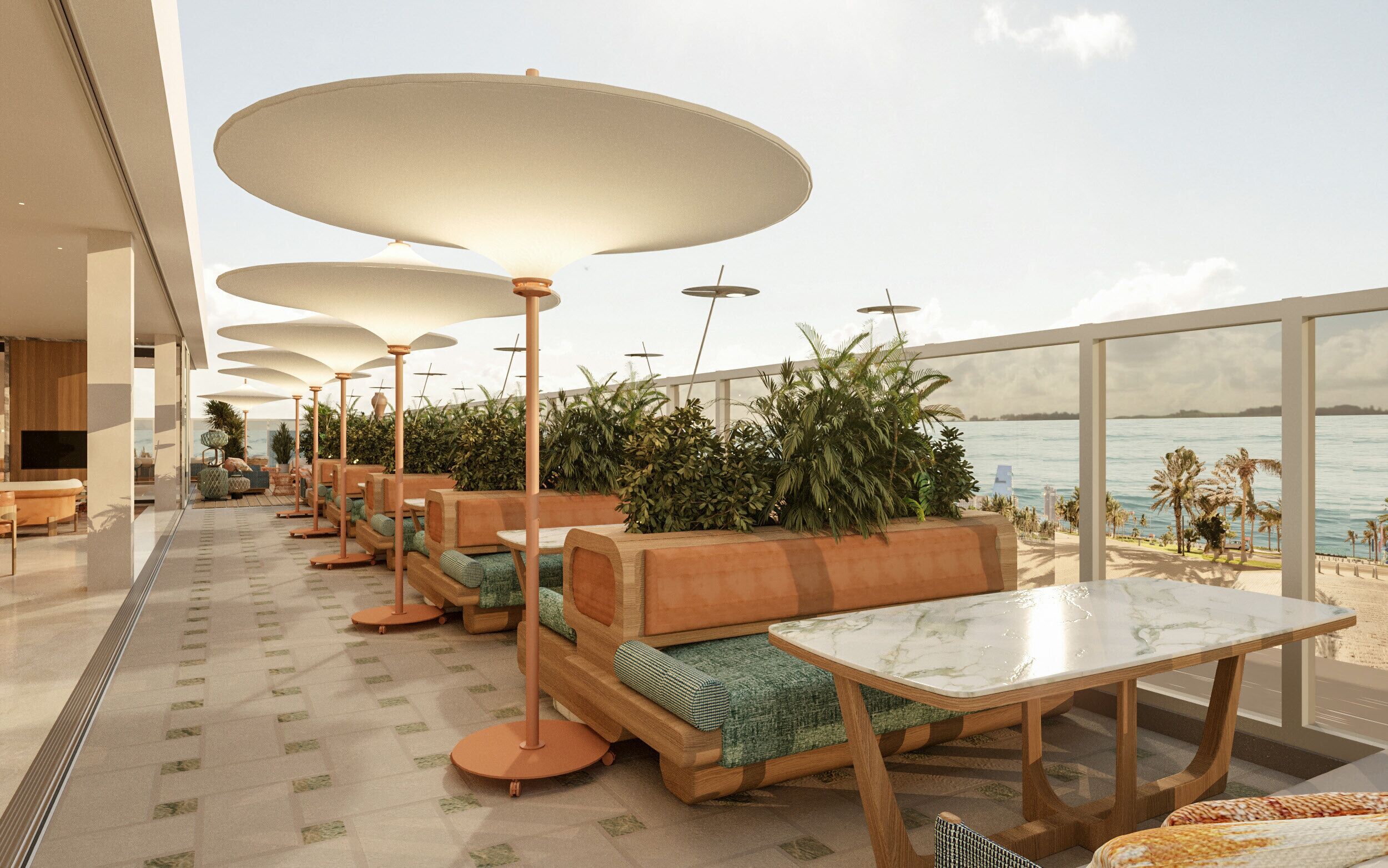 A rooftop terrace with outdoor seating, large umbrellas, and a view of the sea.