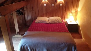 A cozy wooden room with a bed, two wall-mounted lights, and a nightstand with a lamp. - Apartment for 5 people, pets allowed in Valloire (Valloire)