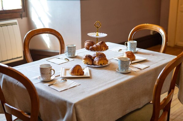 A table set with croissants, a tiered pastry stand, and teacups. - Guest Room – Château de la Rive – Sleeps 10 (Cruet)