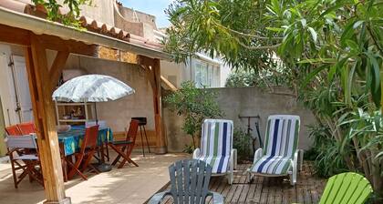 Villa with covered terrace and garden.