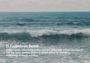 A beach with waves, golden sands, and a view of Old San Juan. - Olimpo Court by Otium (San Juan)