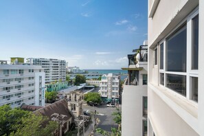 A view of a coastal cityscape with modern buildings, a visible hotel, and a clear sky. - Olimpo Court by Otium (San Juan)