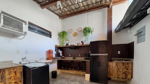 A compact kitchen with a sink, countertop, and a refrigerator.