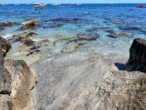 A rocky shoreline with clear water and boats in the distance. - Apartment 'Almaré Mondello' with Balcony, Wi-Fi and Air Conditioning (Palermo)