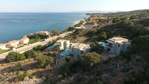 A coastal property with a swimming pool, modern architecture, and a view of the sea. - Villa Mare ,  this brand new stylish villa boasts spectacular sea views! (Skala)