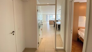 A modern interior with a glass door leading to a dining area and a bedroom. - Apartment in Nieuwpoort-bad Near Beach (Nieuwpoort)