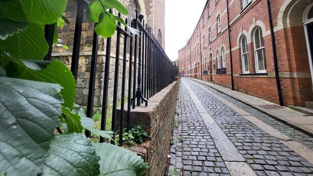 A cobblestone street flanked by brick buildings with arched windows and a black iron fence. - St Martins Walk - Three Bedroom Apartment, Sleeps 6 (York)