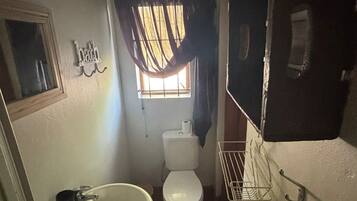 Een douche, handdoeken, zeep, toiletpapier